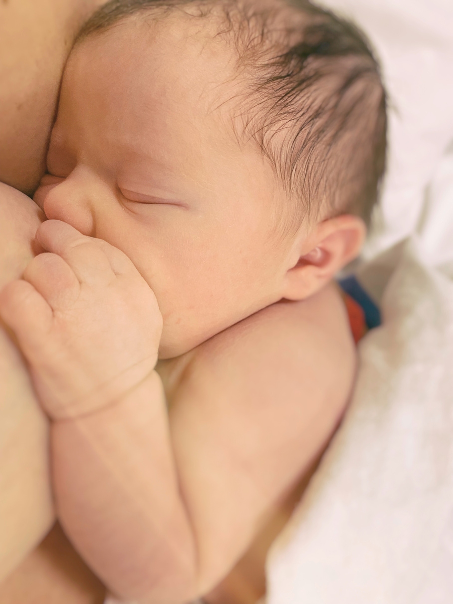 Newborn baby breastfeeding skin to skin